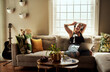 © Malambo/peopleimages.com - Laptop, movies and woman with headphones, relax and chilling with radio, streaming and comfortable. Home, sound and calm on sofa, listening and person in living room, podcast and pet in apartment