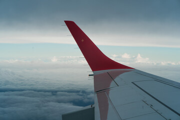 dramatic sky from a plane with a wing visible