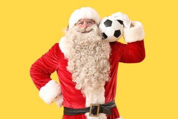 Sticker - Santa Claus with soccer ball on yellow background