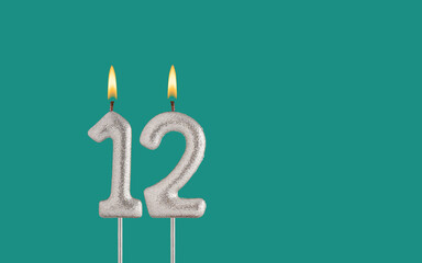 Canvas Print - Birthday candle number 12 - Card on a green background.