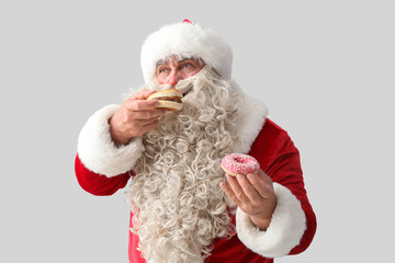 Poster - Santa Claus with tasty donut and burger on white background