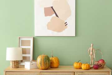 Poster - Pumpkins with wooden mannequin, apples and lamp on commode in living room