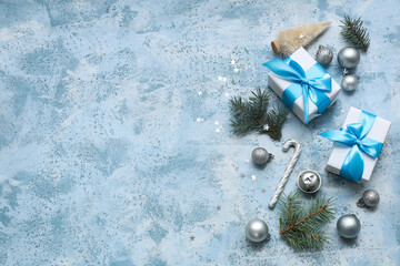 Gifts and Christmas decorations on blue background with space for text