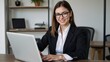 © Pixel Matrix - Professional African-American businesswoman confidently works on her laptop in an office setting while dressed in a suit and glasses