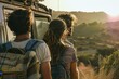 © Alu-Art - Friends enjoying a sunset view atop a vintage van at a coastal highway overlooking the ocean, capturing the essence of adventure and camaraderie in the golden hour
