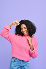 Wall Mural - Happy ethnic Afro American female model looking at camera with yes gesture. Excited young pretty gen z African girl celebrating win standing isolated on purple background. Vertical photo.