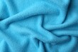 © New Africa - Clean light blue microfiber cloth as background, top view