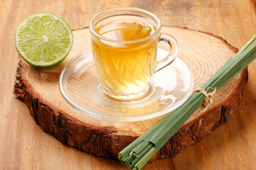 lemongrass tea in glass cup on bamboo table. Close up view