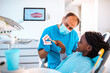 © Geber86 - Professional dentist working on a little girls teeth in his dental office