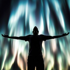 A silhouetted figure stands with arms outstretched against a backdrop of vibrant, swirling lights, evoking a sense of wonder and connection to nature.