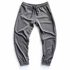 Wall Mural - A pair of slim-fit grey men's sports pants, neatly displayed on a clean white background, highlighting the sleek and modern design