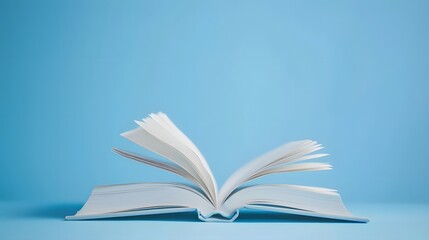 Wall Mural - A book is open on the table, with a white, blurred background and soft light. The pages of the book show colorful text in a high-definition photography style.