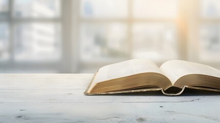 Wall Mural - A book is open on the table, with a white, blurred background and soft light. The pages of the book show colorful text in a high-definition photography style.