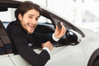 © Prostock-studio - Handsome Auto Vender Showing Car Key Sitting In Driver's Seat Smiling To Camera