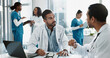 © PeakPoints/peopleimages.com - Discussion, men and doctors in office at hospital for planning medical diagnosis, treatment or surgery. Meeting, interview and healthcare worker with board director at clinic for feedback or review.