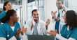 © PeakPoints/peopleimages.com - Group, doctor and laptop with applause in hospital for medical success, celebration and promotion news. Happy, people and clapping with online email, healthcare winner and congratulations on funding