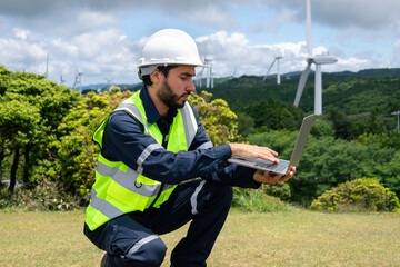 Young maintenance engineer man working in wind turbine on the mountain, Power generation Saving and using renewable energy concept.