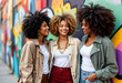 © rachid - Three Black Women Friends Smiling In Front of a Colorful Mural