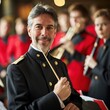 © Robert Kneschke - Confident band leader directing with baton in formal uniform