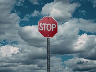 Close-Up of a Red Stop Sign Against a Dramatic Cloudy Sky, Symbolizing Caution and Safety in Urban Environments