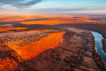 Wall Mural - Red rays of evening light illuminate the slopes of the majestic Dniester canyon. Ukraine, Europe.