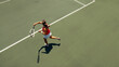 © Jacob Lund - Aerial view of female tennis player executing a forehand on court