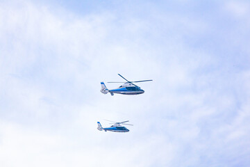 Two transport helicopters are flying in the sky.