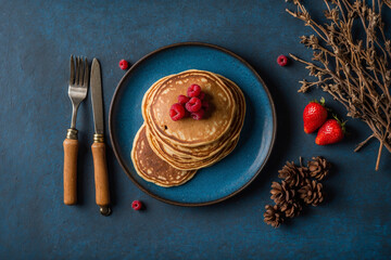 Flat lay pancakes on wooden table on blue table