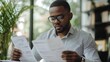 © inthasone - A tax lawyer analyzing a corporate financial report to ensure tax compliance