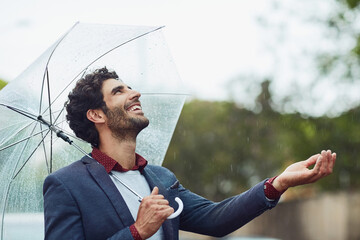 Business, travel and man with umbrella, rain and happiness with commute, nature and smile. Person, outdoor and employee with season, morning or consultant with break, winter or excited with water