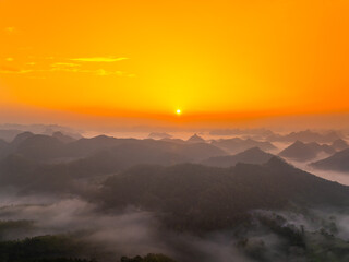 Orange sky and sea of clouds before sunrise. A peaceful, refreshing feeling. View of the hills surrounding Ba Quang, Ha Lang district, Cao Bang province, Vietnam