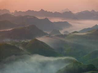 Orange sky and sea of clouds before sunrise. A peaceful, refreshing feeling. View of the hills surrounding Ba Quang, Ha Lang district, Cao Bang province, Vietnam