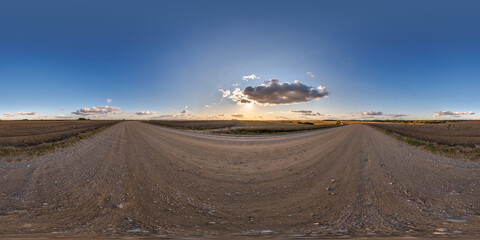 Wall Mural - hdri 360 panorama on gravel road among fields in nasty evening before storm and sunset in equirectan