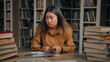 © Yuliia - Sad frustrated stressed asian woman girl in university library checking email reading bad news on mobile phone disappointed chinese female student getting notification failing exam losing scholarship