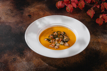 Russian cuisine. Pumpkin soup with shrimps