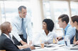 © STEEXBuyout/peopleimages.com - Businessman, presentation and collaboration with team for meeting, corporate plan or project at office. Man, executive or speaker talking to group of employees for business improvement or development