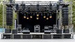 © Atlantist studio - A well-equipped outdoor stage setup, featuring audio speakers, lights, and a spacious platform for live performances.
