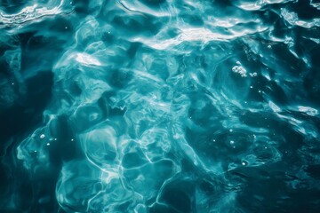 Wall Mural - sunlight reflecting on a crystal clear turquoise water surface background for aqua sea, ocean design