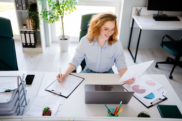 Photo of lovely young lady reading papers dressed formalwear business manager comfortable startup office room interior