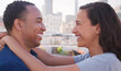 © Monkey Business - Portrait Of Romantic Couple Looking At Each Other On Rooftop Terrace With City Skyline In Background
