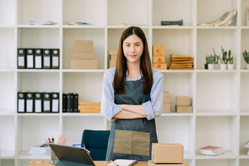 Young businesswoman managing online sales and shipping from a modern home office.