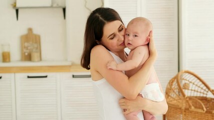 mom with a baby, an international family, a caucasian mom with an asian baby in the bedroom gently h