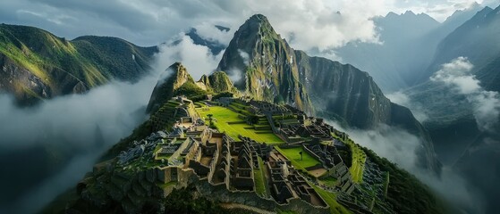 Majestic aerial view of Machu Picchu, set against lush green mountains and misty clouds, showcasing the ancient Incan ruins and breathtaking natural beauty.