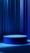 © Maria Mikhaylichenko - Elegant blue cylindrical podium against a backdrop of deep blue curtains, creating a luxurious and mysterious atmosphere for product display or presentations.