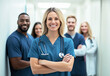 © Nazlykhan - Diverse medical team smiling confidently in hospital corridor