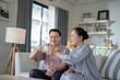 © ultramansk - An elderly couple enjoys a peaceful moment at home, sharing smiles and drinks. The warm and cozy atmosphere emphasizes their deep connection, happiness, and the comfort of spending time together.