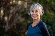 © Baba Images - Portrait of a smiling active senior woman in sport clothes at home