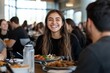 © Milos - A young woman with a radiant smile shares a delightful meal with friends at a restaurant, capturing happiness and togetherness in a relaxed atmosphere.