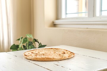 Wall Mural - Thin pita bread on a white wooden table background