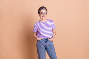 Poster - Photo of lovely adorable woman wear striped trendy clothes empty space isolated on beige color background